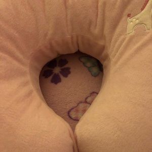 A baby pink and gray boppy